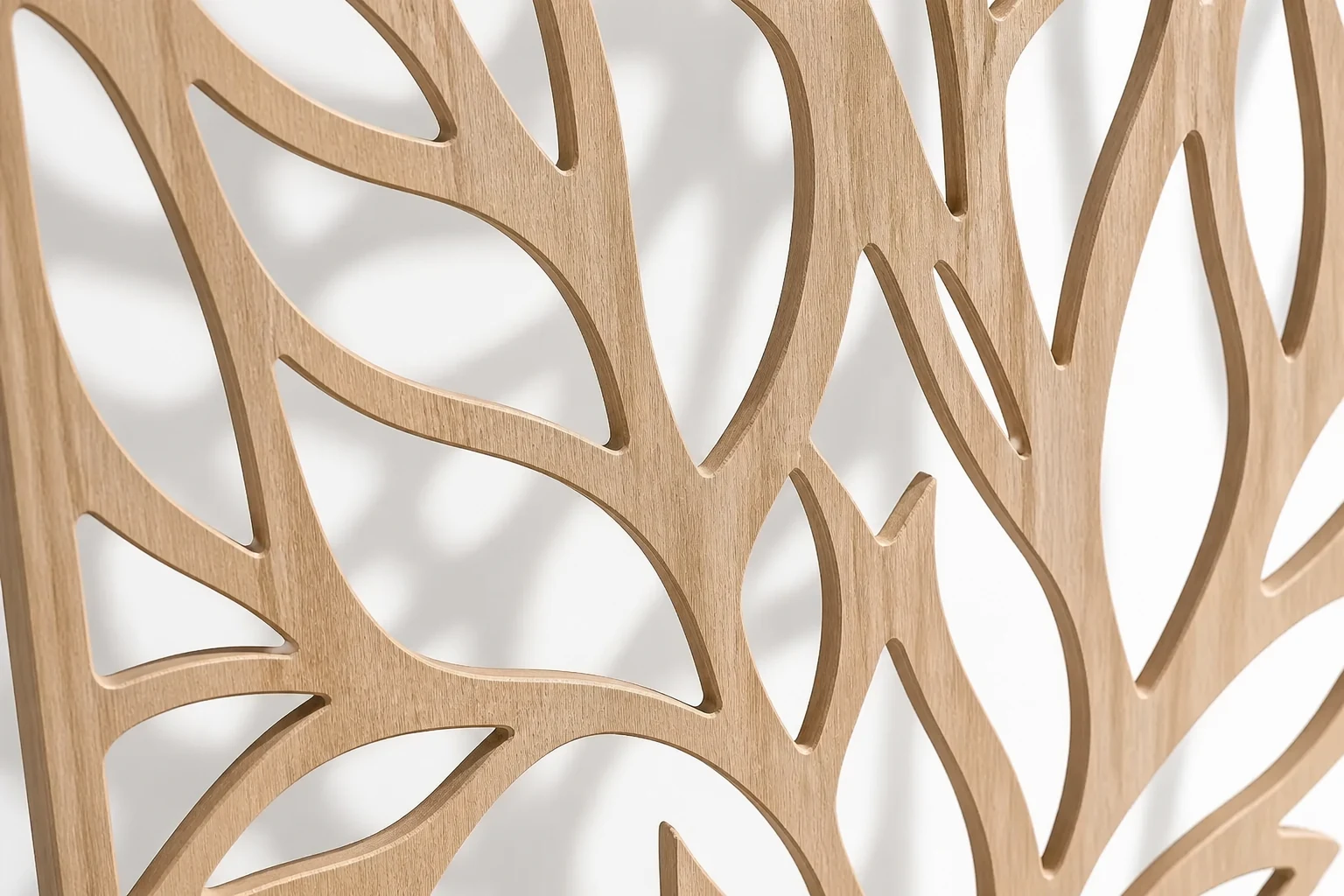 Close-up of a pale oak CNC screen with flowing botanical cutouts