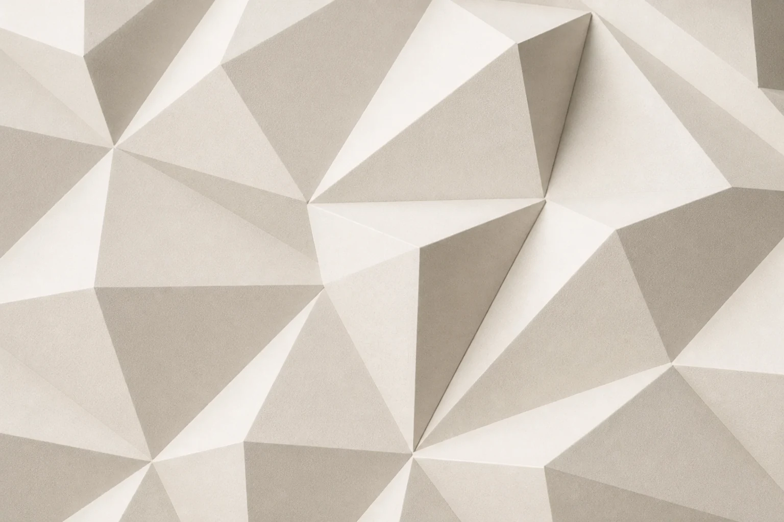 Close-up of an ivory CNC panel with angular faceted relief