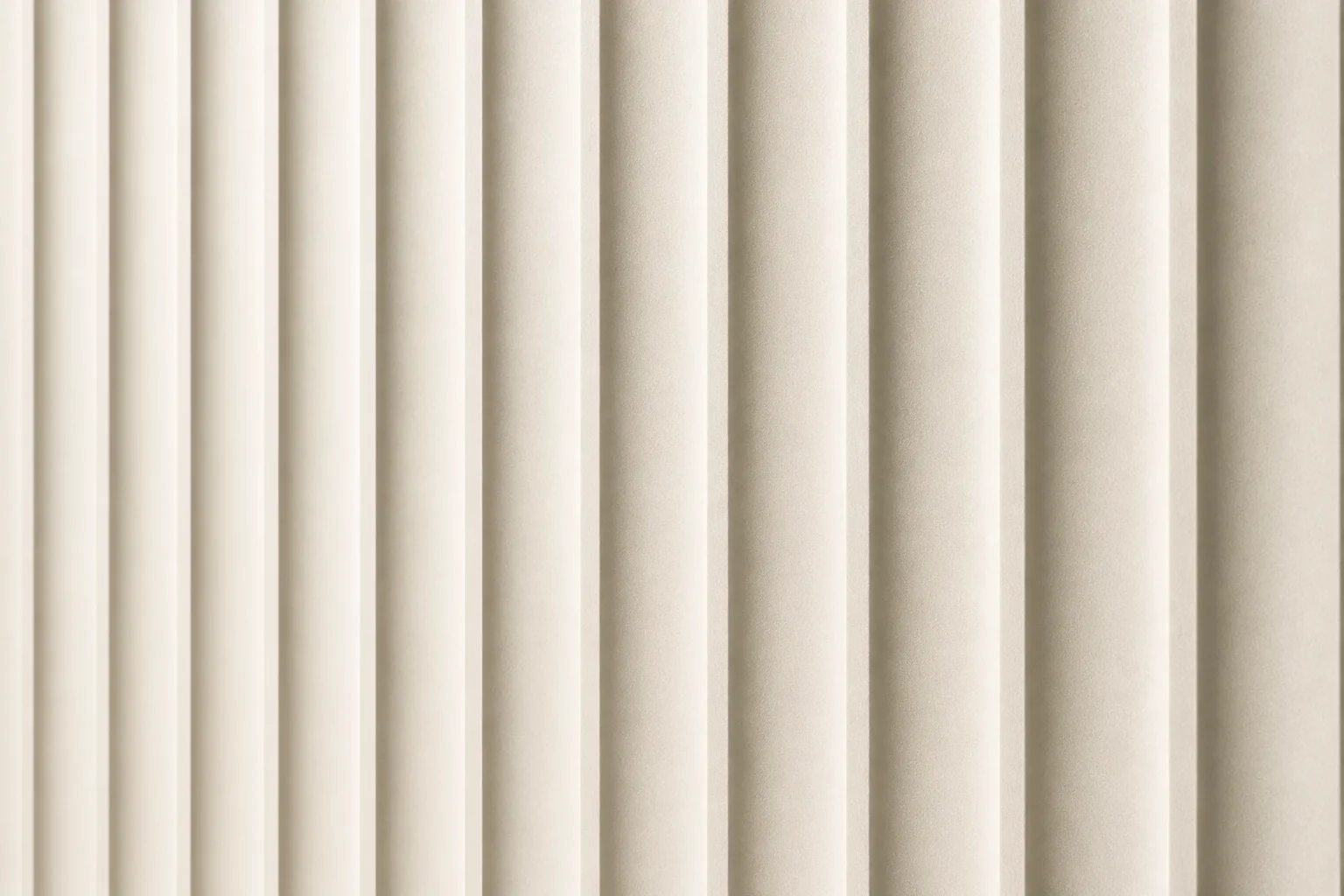 Close-up of an ivory CNC panel with repeated vertical fluted channels