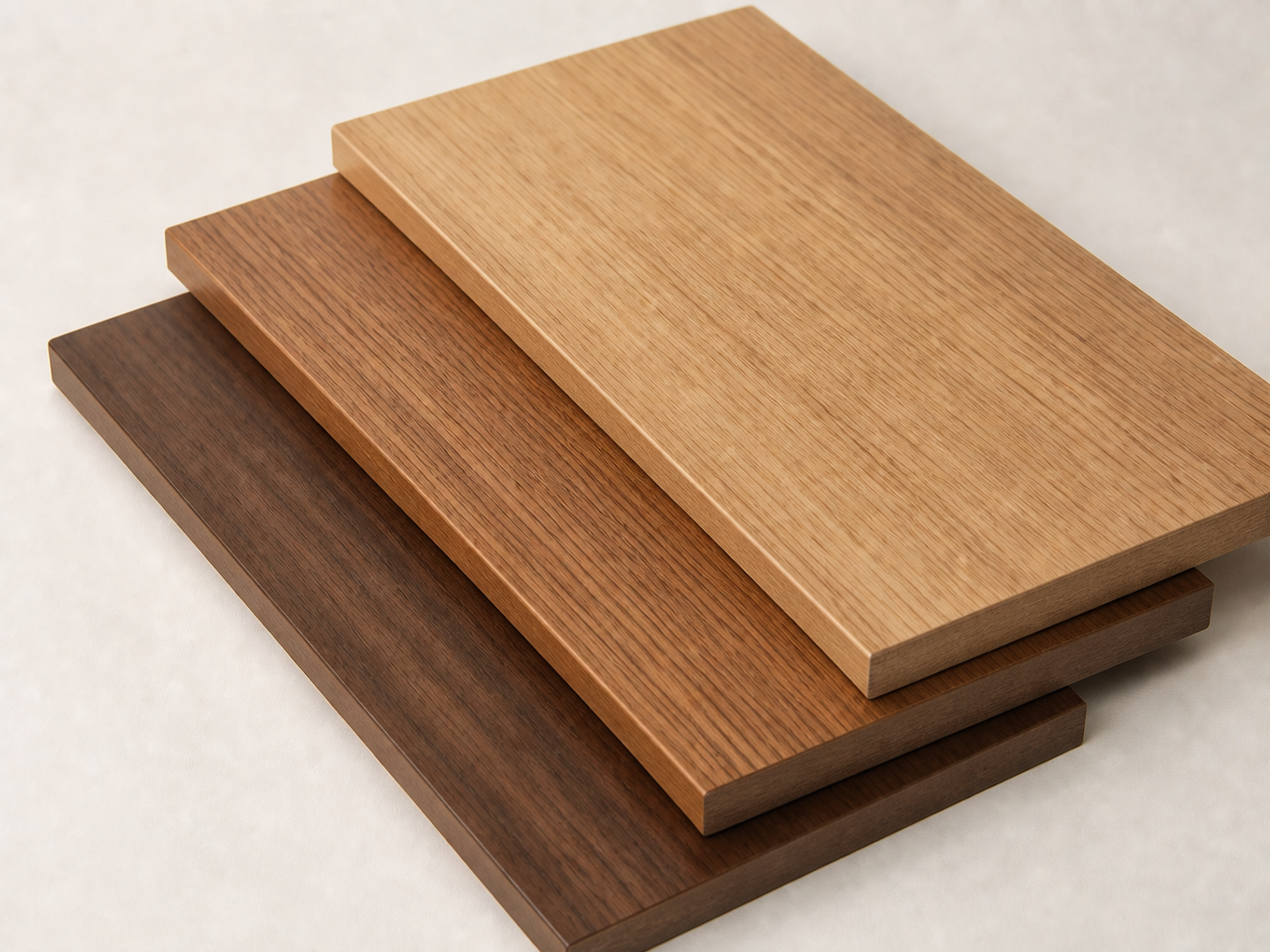 Three stacked woodgrain melamine panel samples with clean colour-matched finished edging