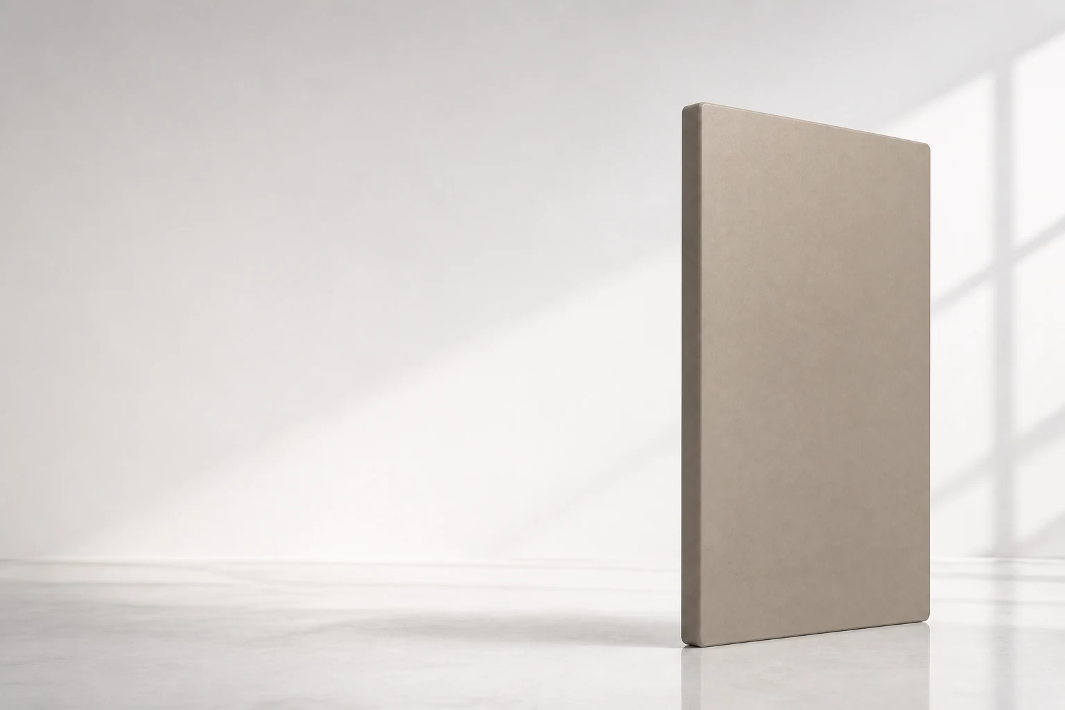 Substantial warm greige matte spray panel positioned in a bright studio